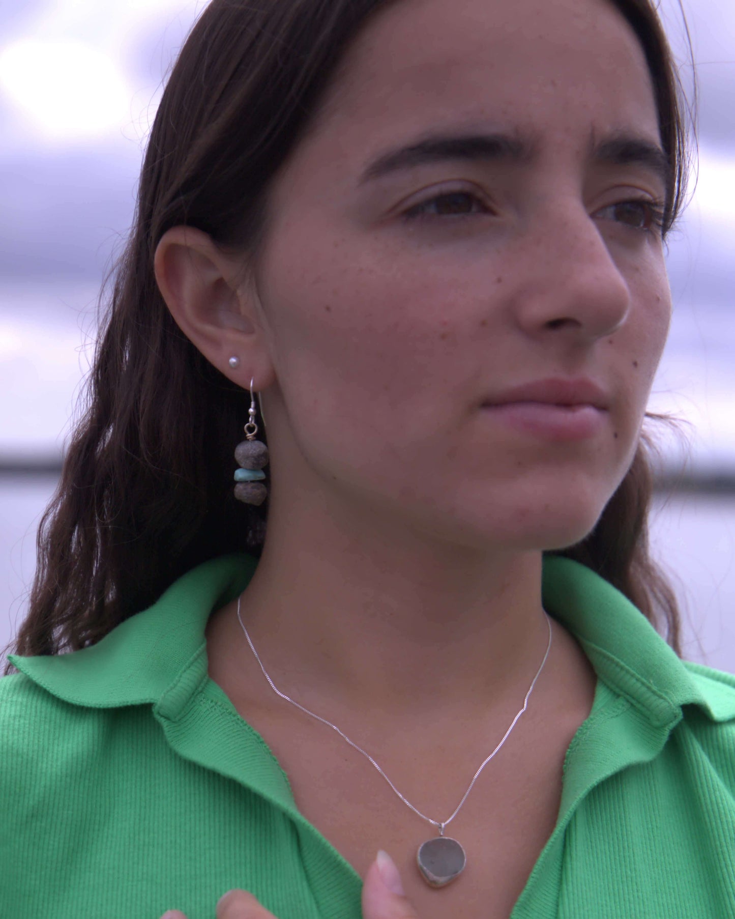 Model wearing Personalised Earring are made from 30,000 year mammoth beads found on the Jurassic coast in the south of England