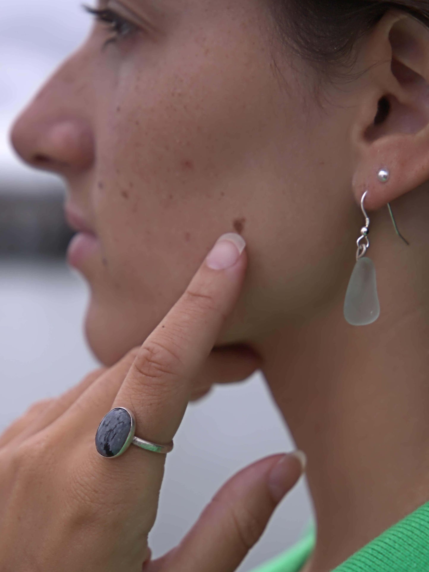 model wearing earth and silver jewellery sea glass earrings